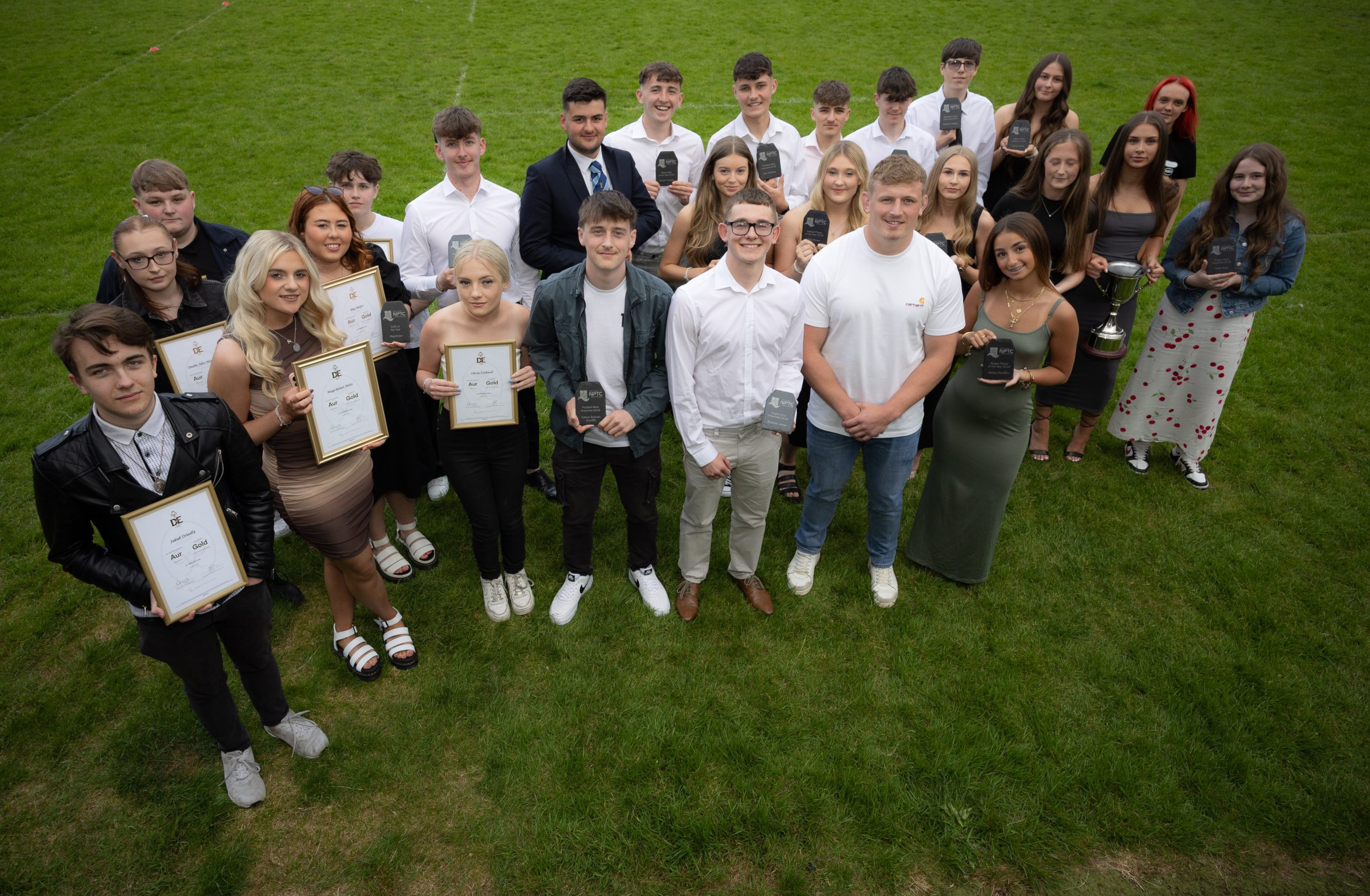 Sports award winners with their trophie and certificates being pictured from above with rugby player Jac Morgan.
