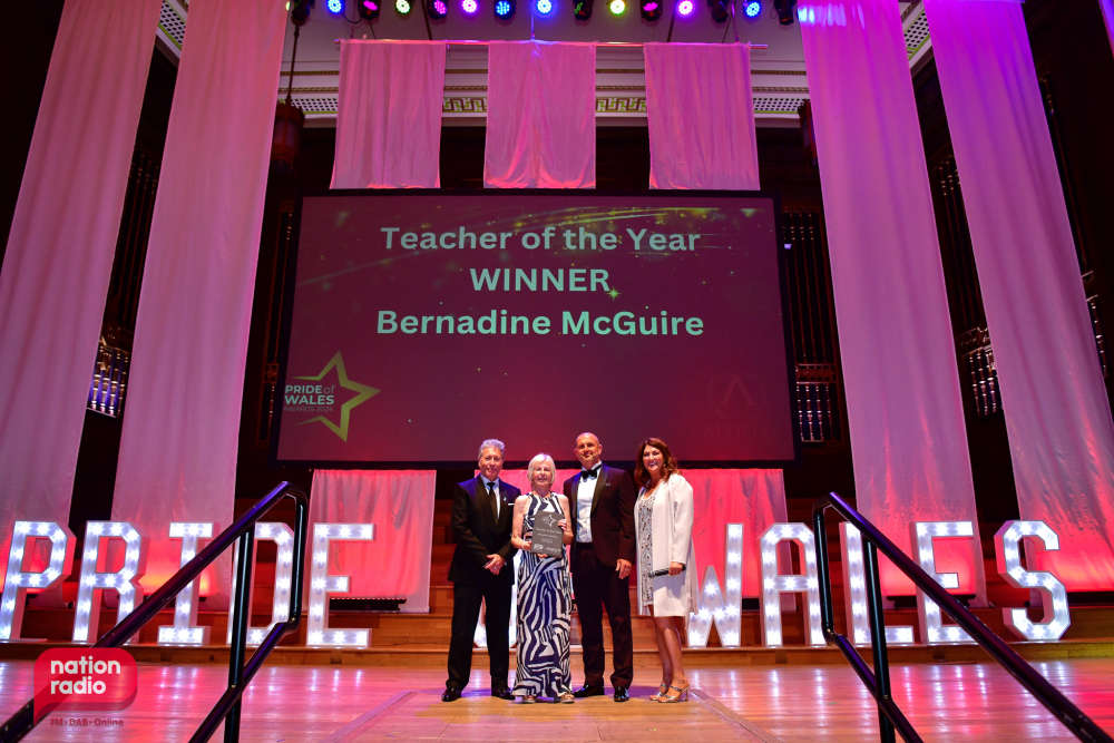 Bernadine McGuire on stage receiving the Teacher of the Year award at the Pride of Wales Awards.