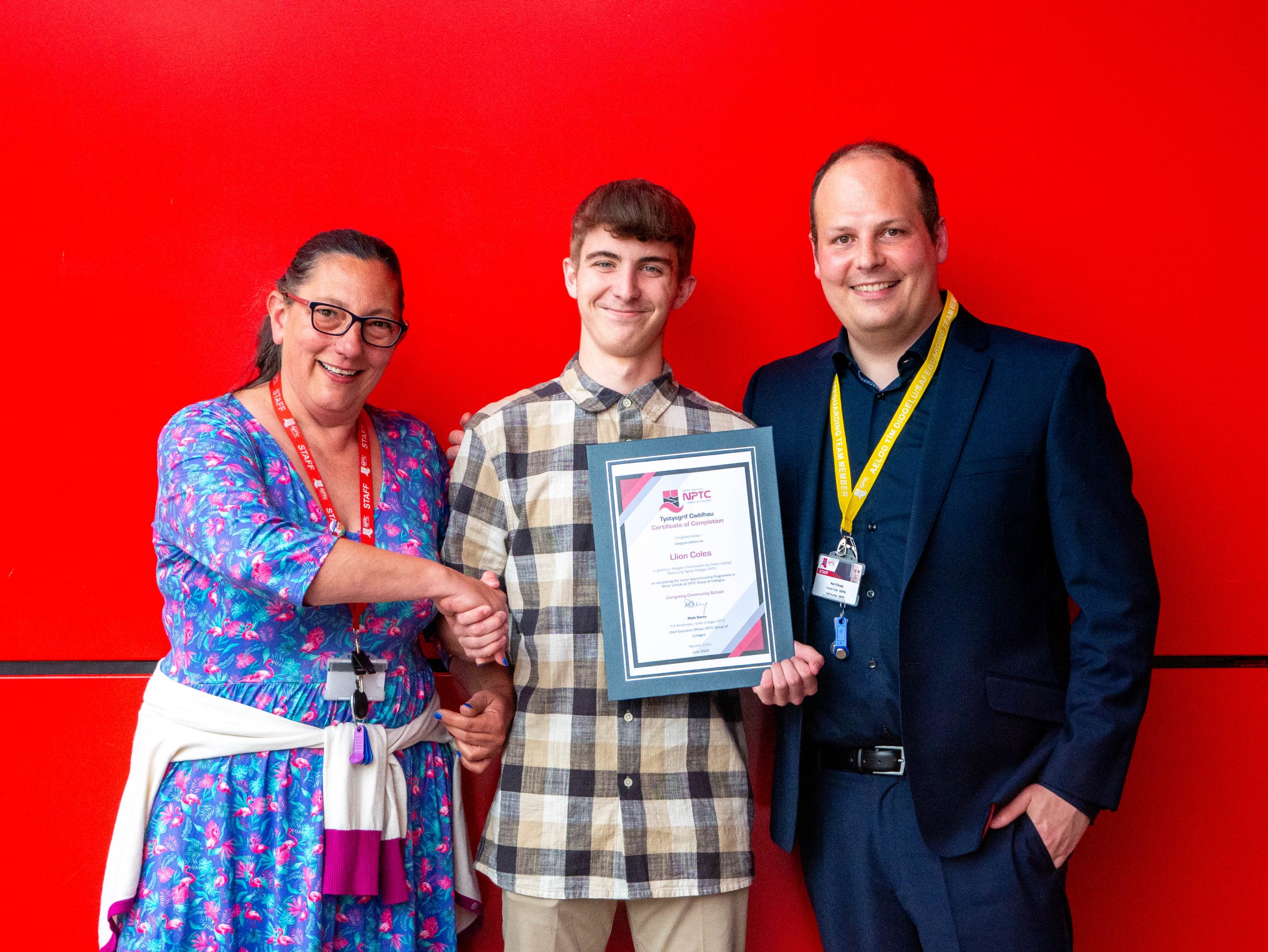 Junior Apprentice with his award congratulated by college staff