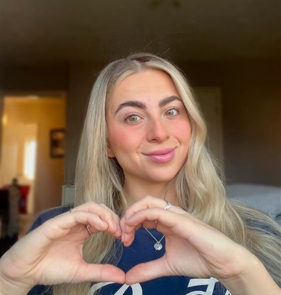 HE Student Sophia Rabaiotti doing a heart shape on international Women's day