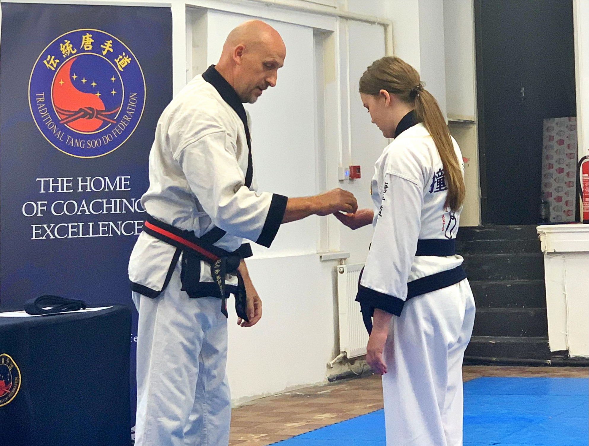 Isabelle Suter receiving a Korean Karate medal.