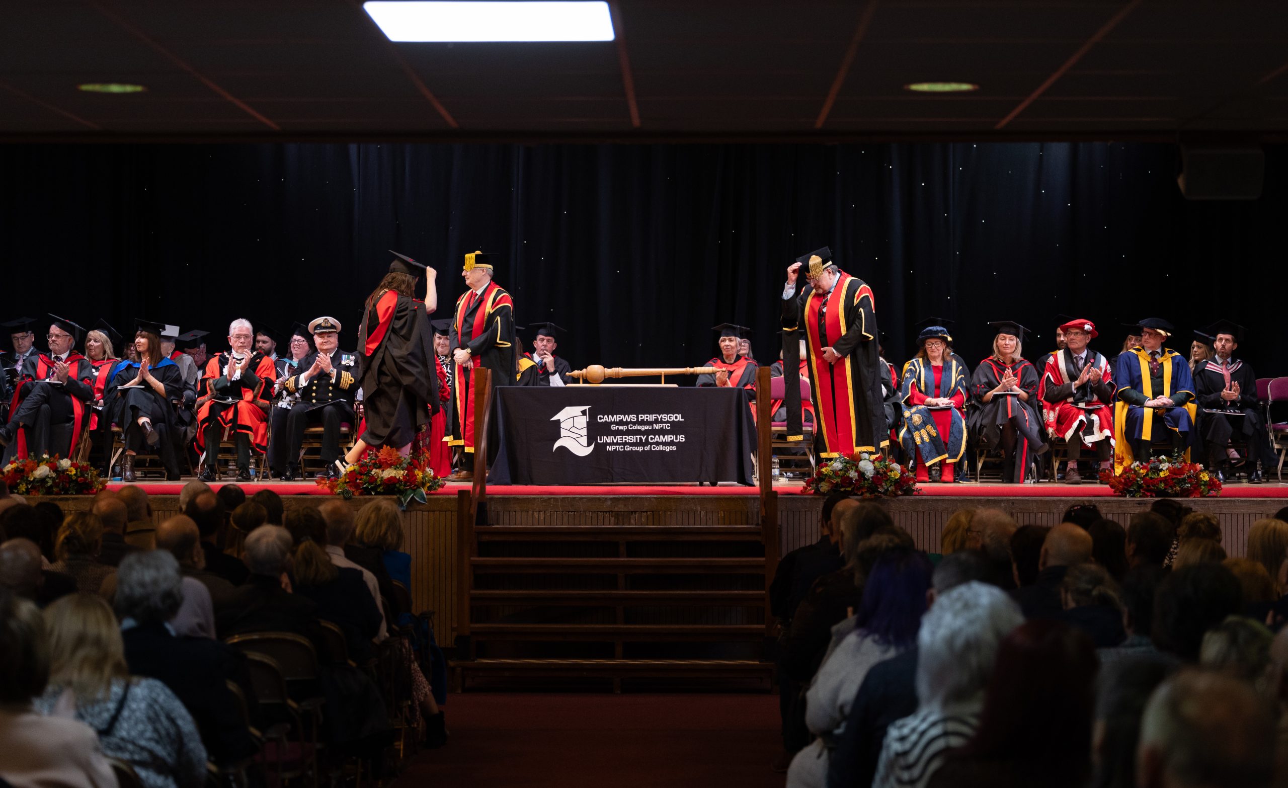 Graduation 2024: Student walking cross the stage doffing her cap