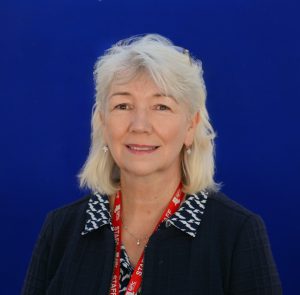 Portrait of Lisa Jenkins on blue background.